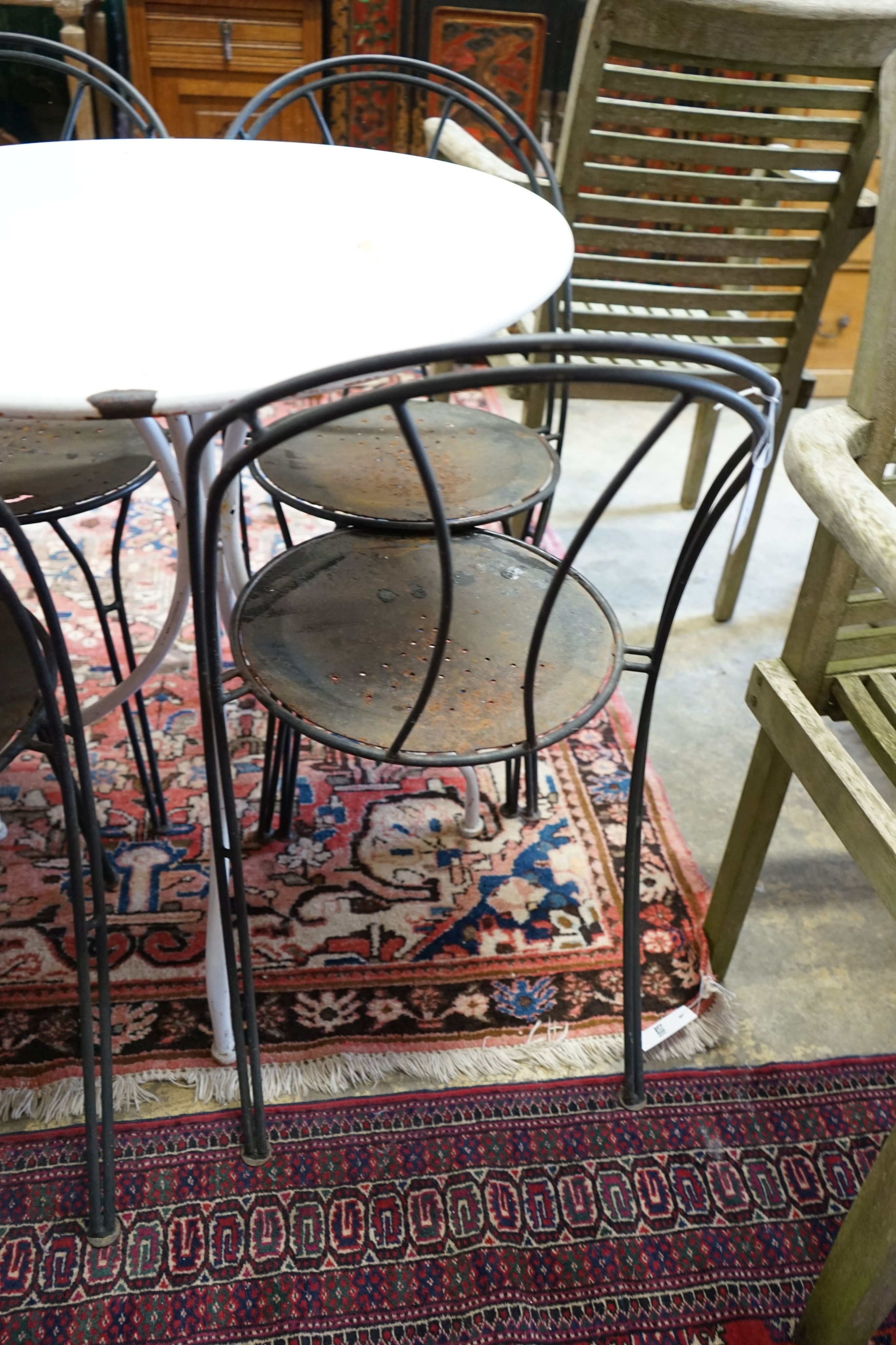 A circular metal garden table, diameter 70cm, height 76cm and four chairs